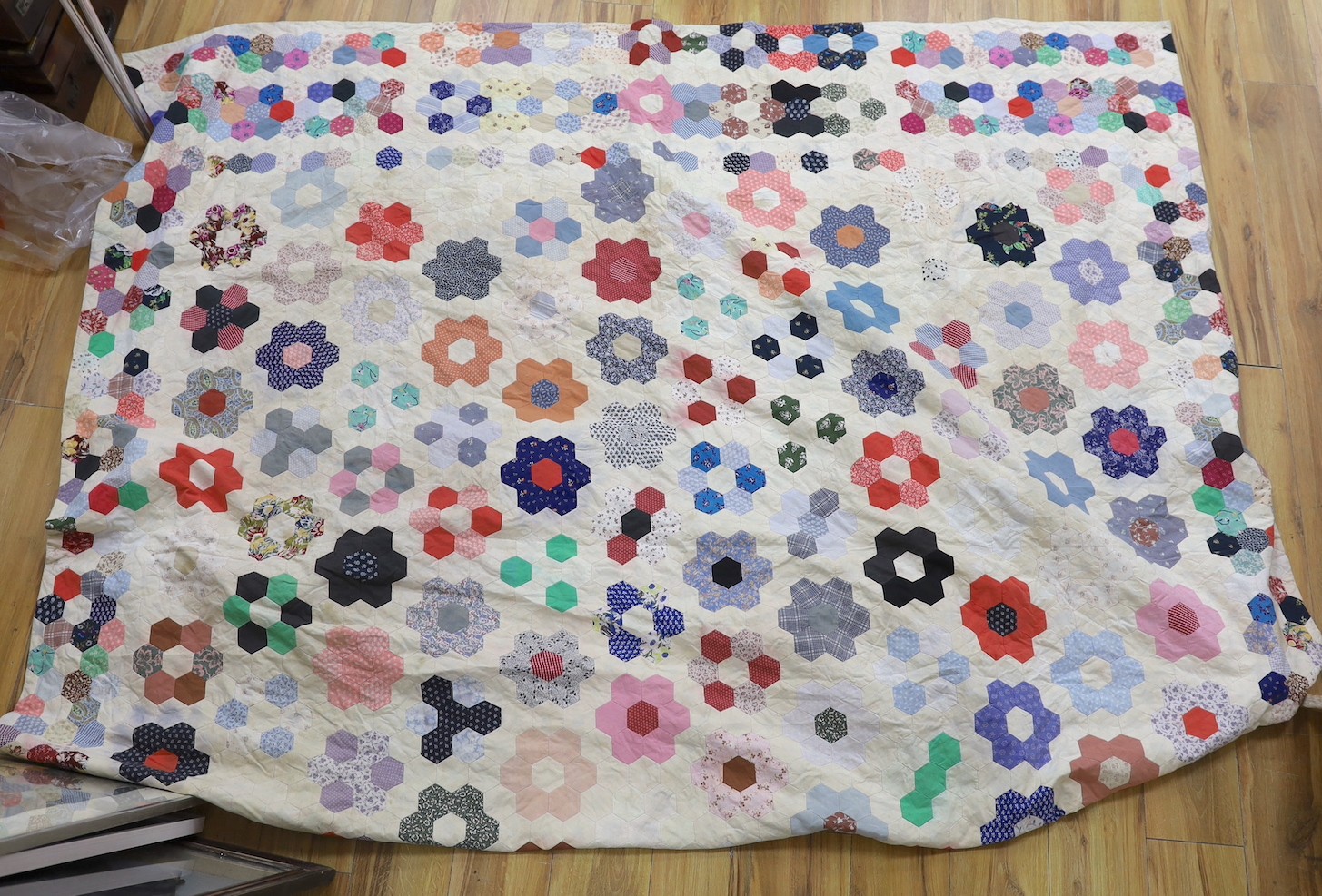 A patchwork quilt, made from Edwardian and later fabrics, 232 cms x 252cms.